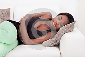 Woman Suffering From Stomachache At Home