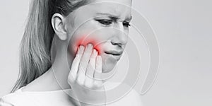 Woman suffering from strong tooth pain, panorama