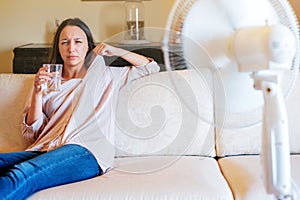 Woman suffering for summer heat refreshing at home