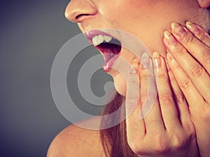 Woman suffering from tooth pain