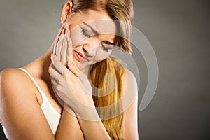 Woman suffering from tooth pain