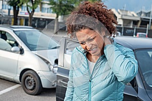 Woman suffering whiplash after bad cars pile up