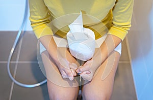 Woman sufferring with Hemorrhoids,Constipation,Diarrhea and sitting on toilet