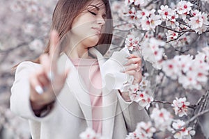 A woman suffers from allergies during the flowering period. photo