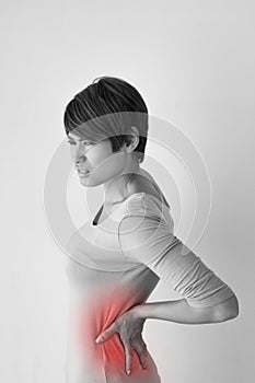 Woman suffers from back pain, concept of office syndrome