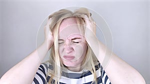 A woman suffers from headache or hypertension. The concept of treatment and prevention of migraine