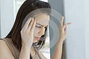 Woman suffers from headache, migraine, stress