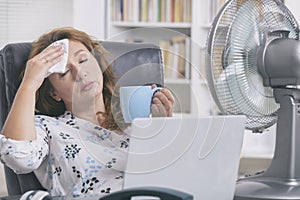 Woman suffers from heat in the office or at home