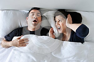 Woman suffers from her partner snoring in bed