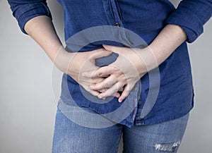 A woman suffers from pain in the appendix. Acute appendicitis, Crohn`s disease, or inflammatory bowel disease. Surgeon examination