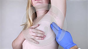 A woman suffers from pain in the armpit. Sweating, unpleasant odor, redness, itching and inflammation in the armpit. Breast Cancer