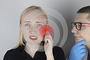 A woman suffers from pain in the ear. The auditory meatus hurts due to otitis media, cerumen plug, ear boil, or trigeminal