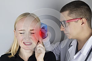 A woman suffers from pain in the ear. The auditory meatus hurts due to otitis media, cerumen plug, ear boil, or trigeminal