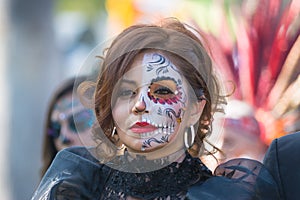 Woman with sugar skull makeup during Day of the Dead