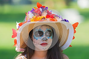 Woman with sugar skull makeup during Day of the Dead