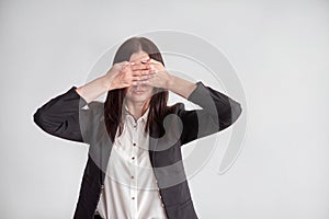 Woman in a suit, blocking her eyes, business compliance concept
