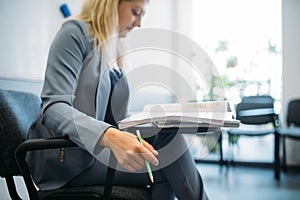 Woman in suit in business office, job search