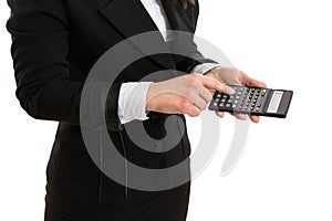 Woman in suit holding a calculator and pressing a button