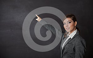Woman in a suit showing blackboard