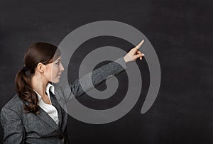 Woman in a suit showing blackboard