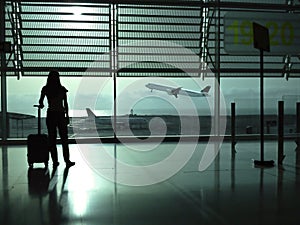 Woman with a suitcase waiting at the airport photo