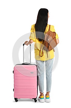 Woman with suitcase and backpack for summer trip on white background, back view. Vacation travel