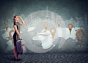 Woman with suitcase ready to explore the world on landmarks map background photo