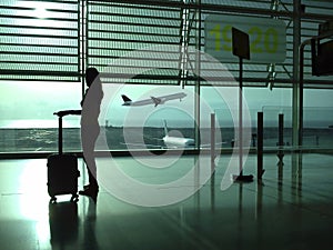 Woman with a suitcase waiting at the airport photo