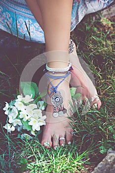 Woman summer boho fashion style details on barefoot anklets and
