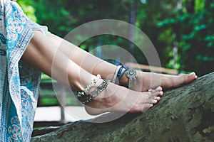 Woman summer boho fashion style details on barefoot anklets and