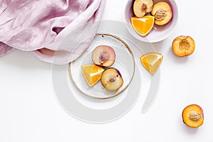 woman summer breackfast with orange and peach fruits and fabric on white background flat lay mockup