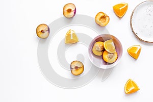 Woman summer breackfast with orange and peach fruits on white background flat lay