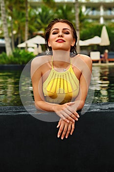 Woman Summer Fashion. Girl Relaxing In Swimming Pool. Beauty