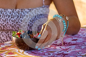 Woman with summer fruits breakfast bowl