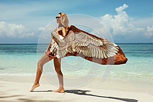 Woman in summer sunbathing on tropical beach on vacation