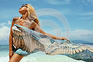 Woman in summer sunbathing on tropical beach on vacation