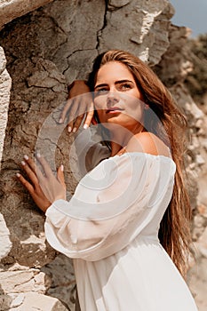 Woman summer travel sea. Happy lady with long hair in white dress enjoy taking photo outdoors for memories. Woman