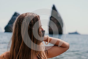 Woman summer travel sea. Happy tourist in black mask enjoy taking picture outdoors for memories. Woman traveler posing