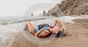 Woman summer travel sea. Happy tourist in blue bikini enjoy taking picture outdoors for memories. Woman traveler posing