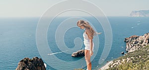 Woman summer travel sea. Happy tourist enjoy taking picture outdoors for memories. Woman traveler posing over sea bay