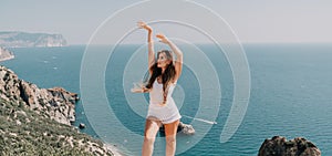 Woman summer travel sea. Happy tourist enjoy taking picture outdoors for memories. Woman traveler posing over sea bay