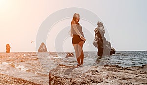 Woman summer travel sea. Happy tourist in hat enjoy taking picture outdoors for memories. Woman traveler posing on the