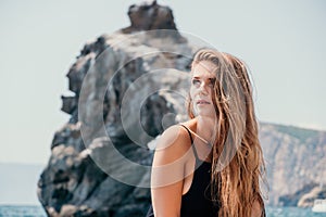 Woman summer travel sea. Happy tourist in hat enjoy taking picture outdoors for memories. Woman traveler posing on the