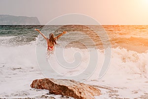 Woman summer travel sea. Happy tourist in red bikini enjoy taking picture outdoors for memories. Woman traveler posing