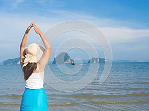 Woman in summer vacation wearing summer hat and beach dress