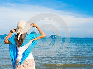 Woman in summer vacation wearing summer hat and beach dress