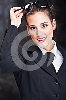 Woman with sun glasses on dark background