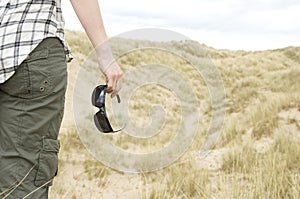 Woman with sun glasses in sand dunes landscape