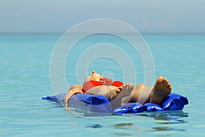 Woman sunbathing on an air mattress