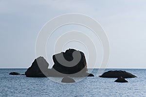 Woman sunbathing on coastal rock koh samui